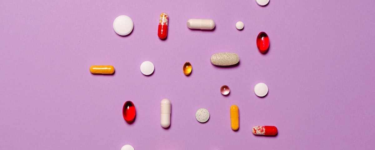 medication pills isolated on purple background