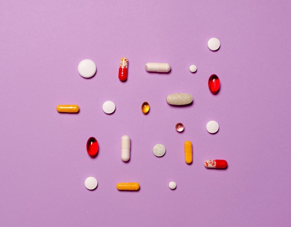 medication pills isolated on purple background